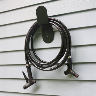 Aquor Ultralight Garden Hose, Utility Spray Nozzle, and Comfort Grip Hose Connector hanging on Matte Black Hose Hanger
