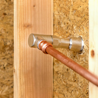 The backend of an Aquor hydrant showcasing a half inch NPT Elbow Inlet connected to copper piping.
