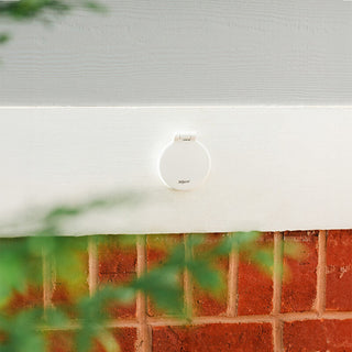 A matte white house hydrant v1+ installed on white wood.