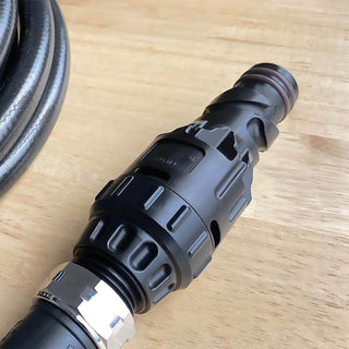 Jet black wide grip vb hose connector sitting on a table.