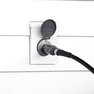 A slate gray wide grip vb hose connector connected to the slate gray house hydrant v1+ installed on white lap siding with a mounting block.