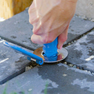 Homeowner's hand inserting the connector into the ground hydrant.