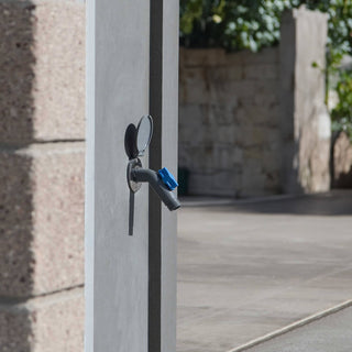 A slate gray removable faucet connector plugged into a slate gray house hydrant v1+.