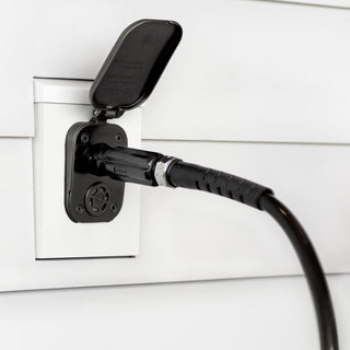 Jet black straight hose connector connected to matte black house hydrant v2+ installed on white lap siding with mounting block.