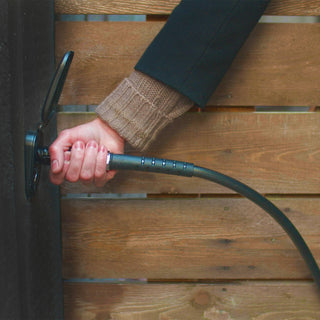 A homeowner inserting a hose and connector into the matte black house hydrant v2+.