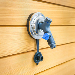 A close view of the Hot and Cold Hydrant and connector on wooden siding.