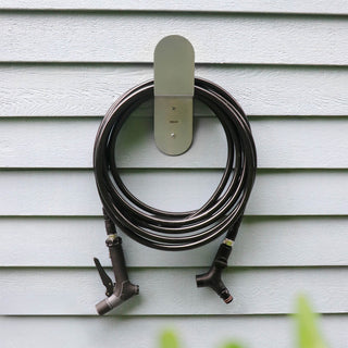 Aquor Ultralight Garden Hose, Utility Spray Nozzle, and Comfort Grip Hose Connector hanging on Stainless Steel Hose Hanger
