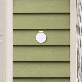 A matte white v1+ debris cover shown on green lap siding.