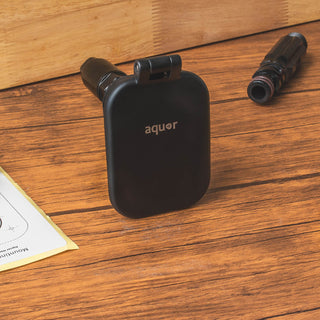 A matte black v2+ debris cover shown sitting on a table.