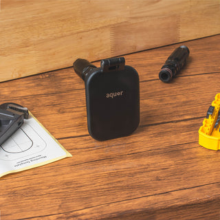 A matte black house hydrant v2+ and a straight connector on a table.