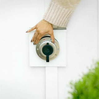 A front view of the Hot and Cold Hydrant with a hand turning the temperature dial. 