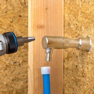 A PEX expander about to expand PEX line, a half inch elbow pex expansion inlet connected to the backend of an Aquor House Hydrant.