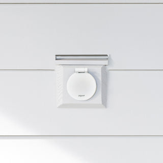 A matte white v1+ debris cover shown on white lap siding.