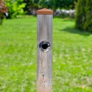 A universal hydrant installed into a singular wooden post.