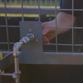 Man connecting to a universal hydrant with a straight hose connector then spraying water.