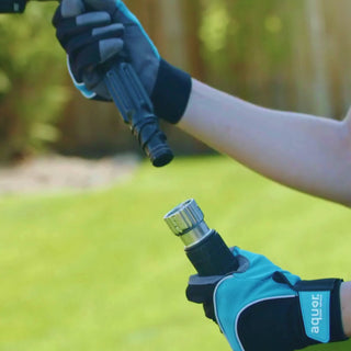 Two hands connect the hose adapter to use a spray nozzle.