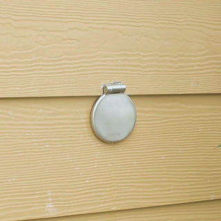 A hand connecting a slate gray vacuum breaker hose connector into a brushed stainless house hydrant v1+.