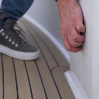 A man connecting an angled hose connector to a marine deckwash.