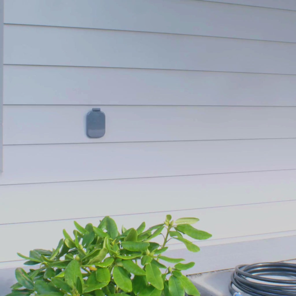 A product shot of the slate gray v2+ installed on white lap siding.