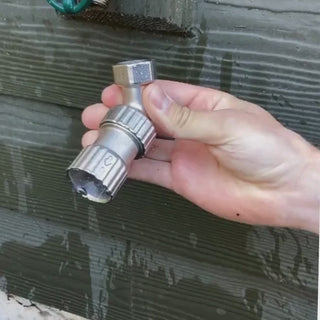 Demonstrating how to twist the faucet adapter onto a hose bibb.